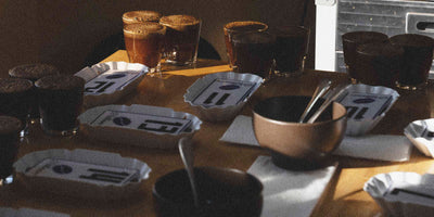 Specialty coffee cupping taking place on a wooden table