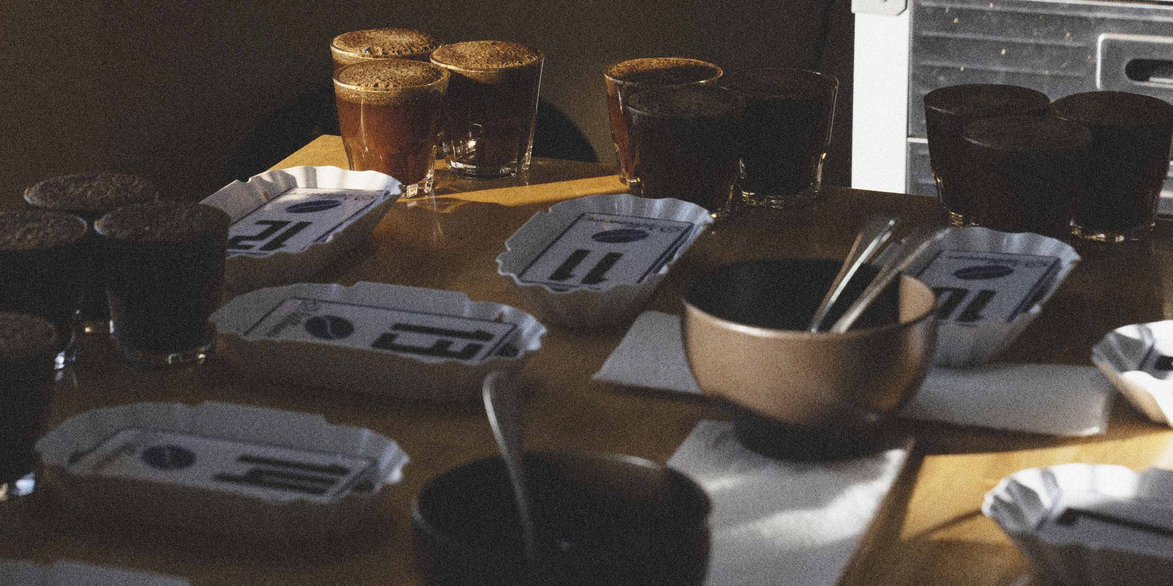 Specialty coffee cupping taking place on a wooden table