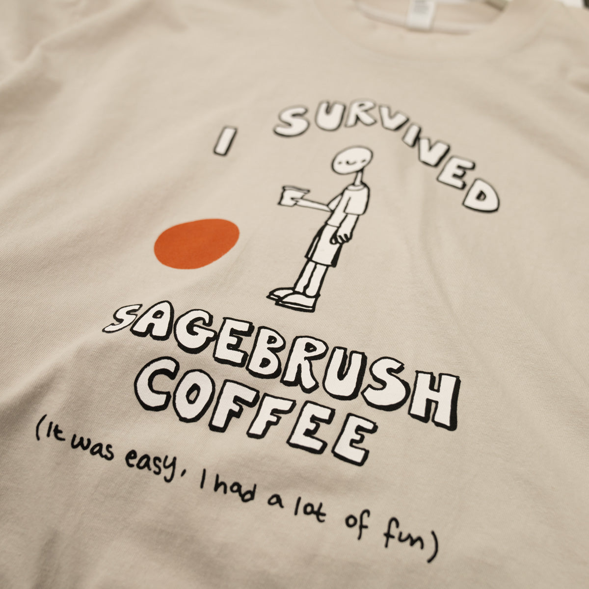 Beige t-shirt with graphic design and text about surviving Sagebrush Coffee