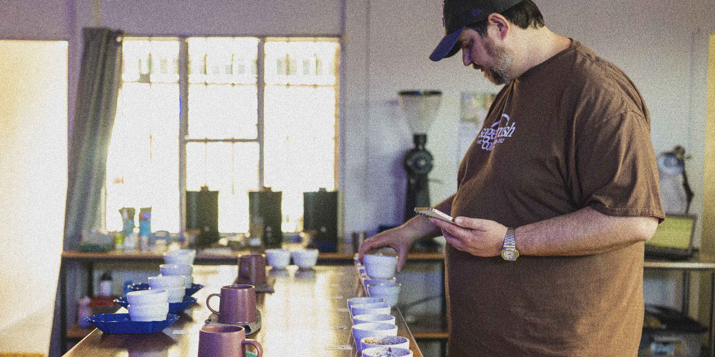 Matt cupping specialty coffee in Selva's cupping room