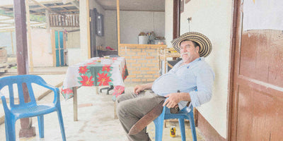 Coffee farmer sitting on the patio of his farm