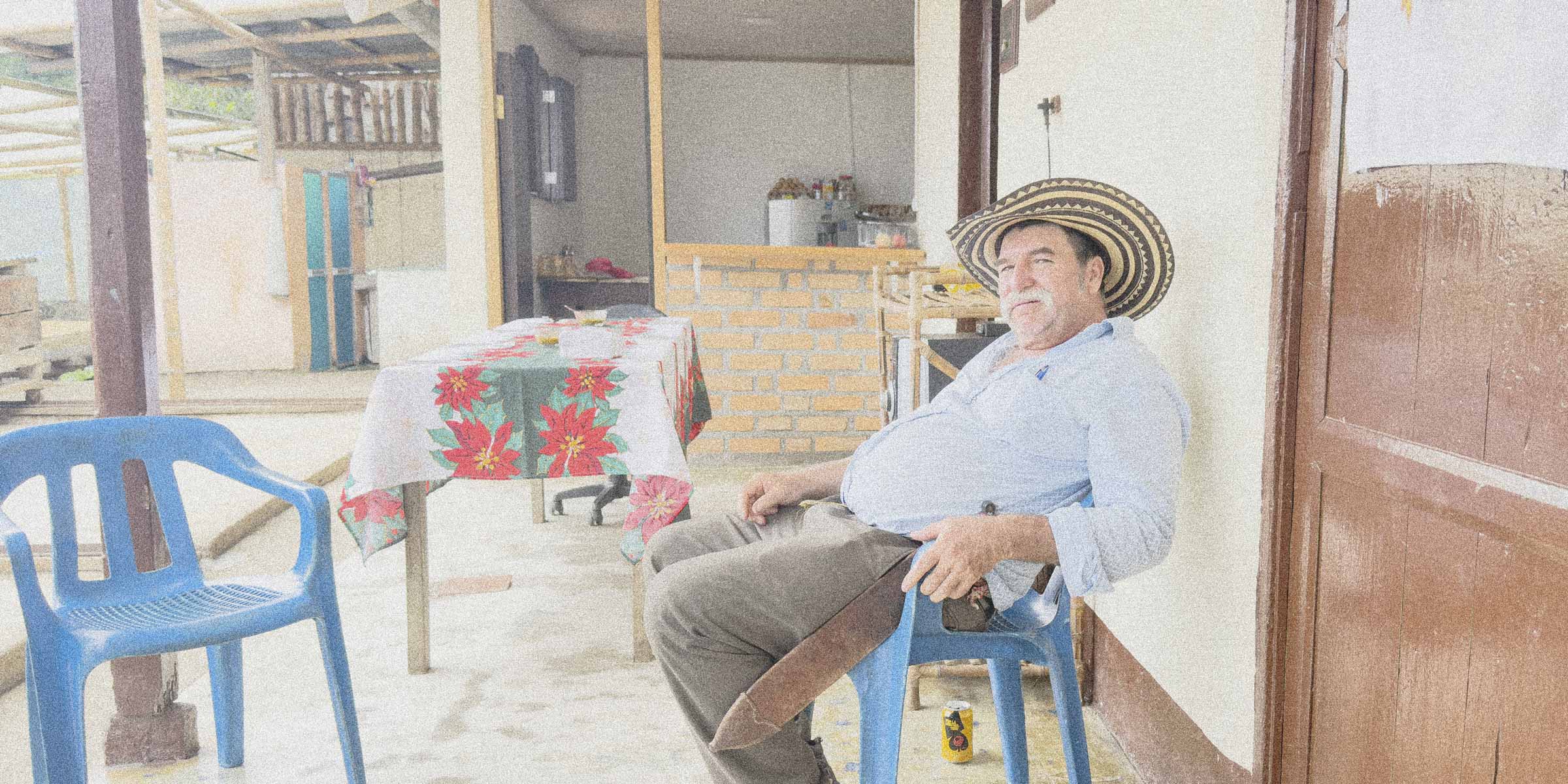 Coffee farmer sitting on the patio of his farm