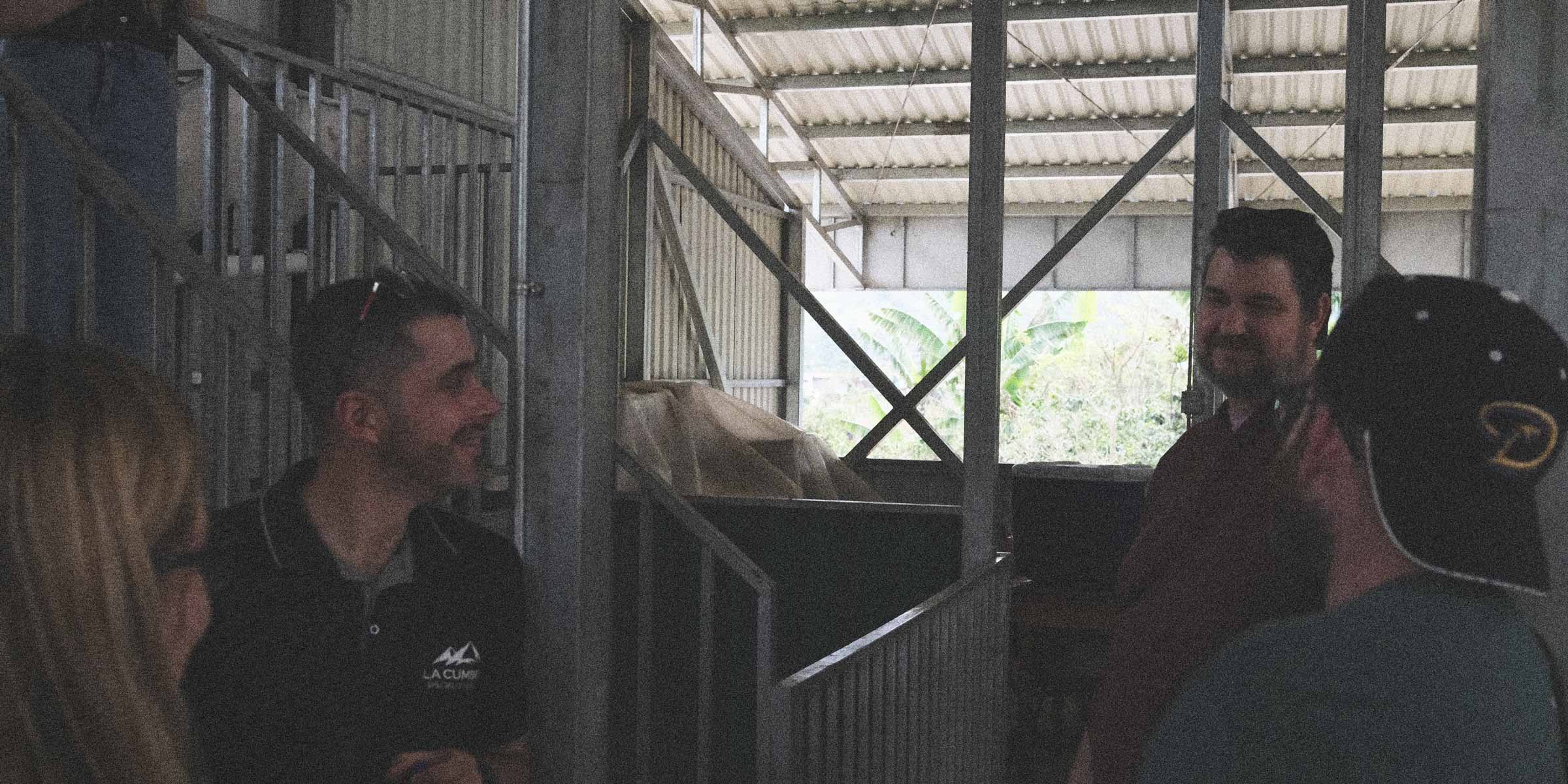 People chatting in a coffee processing facility 