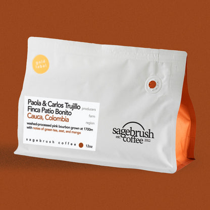 Sagebrush Coffee package of Paola and Carlos Trujillo specialty coffee beans with a dark orange background